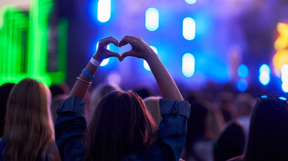 Person making heart symbol with their hands